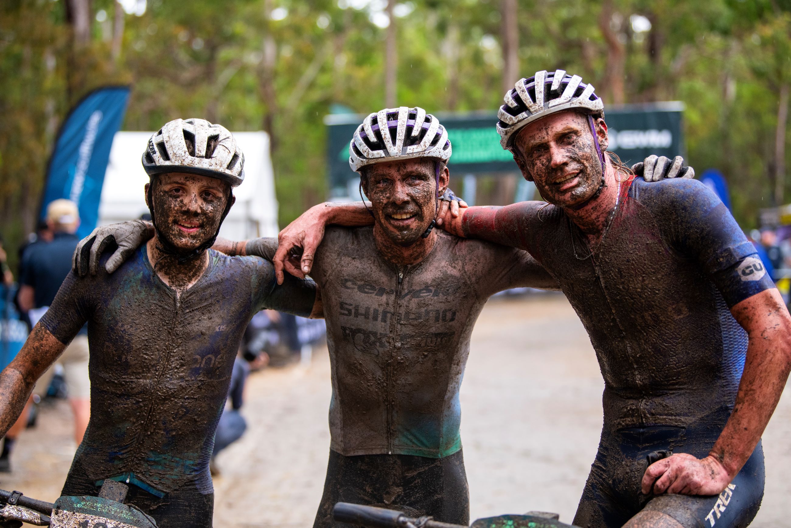 Australian mountain bike riders Jack Ward, Cameron Ivory and Daniel McConnell covered in mud after the 2024 XCO Cross-country Olympic National Championship for Elite Men in Awaba, Lake Macquarie, NSW.